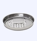 Stainless steel steamer basket on a light gray background