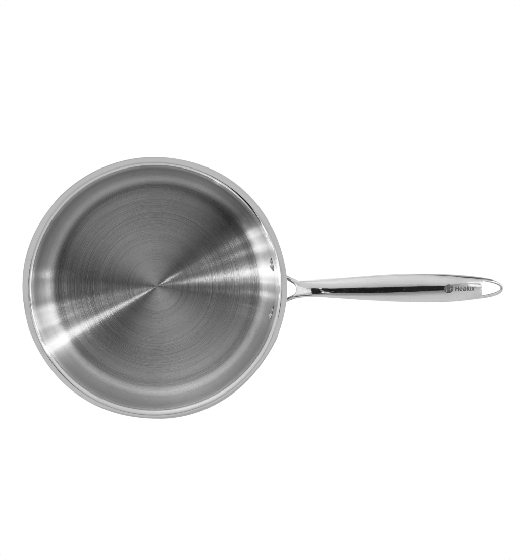 Stainless steel frying pan on a white background