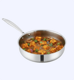 Stainless steel frying pan with tofu dish on a white background