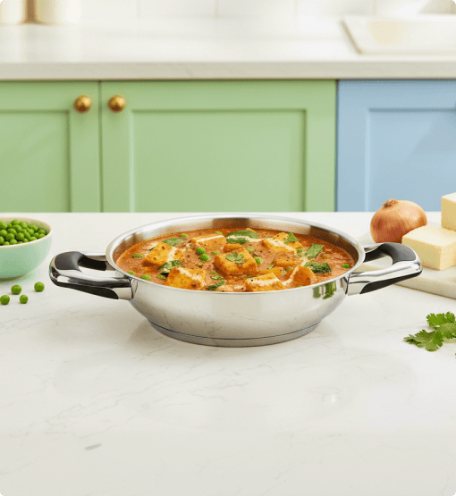 Stainless steel bowl with curry on a kitchen counter