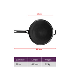 Black cast iron skillet with measurements on a white background