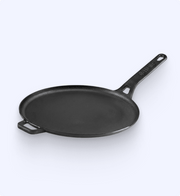 Black frying pan with a silver handle on a white background