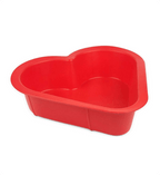 Red heart-shaped plastic basin on a white background