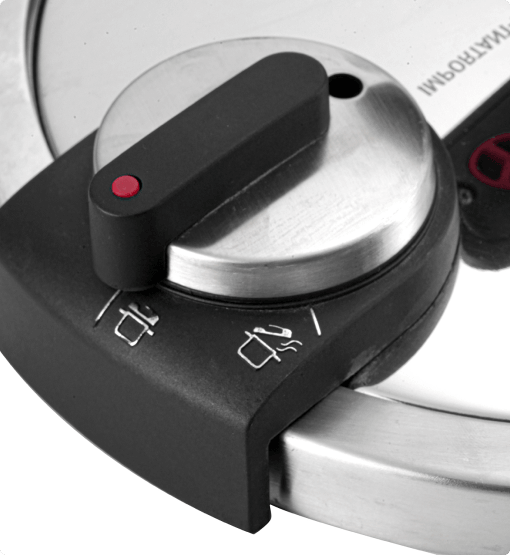 Close-up of a pressure cooker lid with a knob and brand name visible