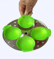 Green egg poacher on a metal tray with a hand lifting one of the compartments.