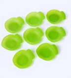 Green silicone mold shapes on a white background
