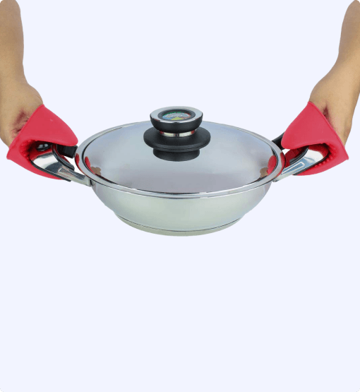 Person holding a silver wok with a lid using red oven mitts on a white background
