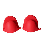 Two red silicone baking cups on a white background