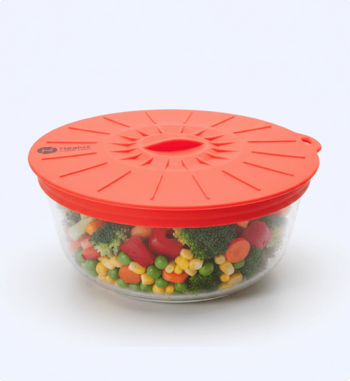Glass container with colorful vegetables and an orange lid on a white background