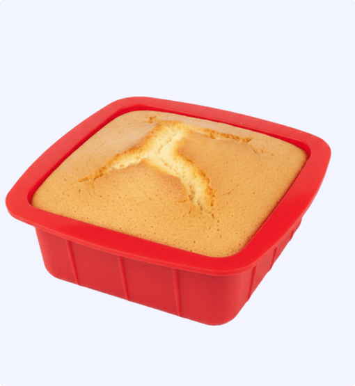 Silicone mold with a baked cake inside on a white background