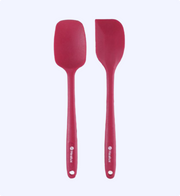 Two red silicone spatulas on a white background