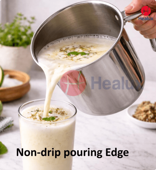Metal pitcher pouring a creamy liquid into a glass with 'Healux' branding.