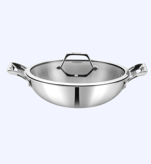 Stainless steel wok with lid on a white background