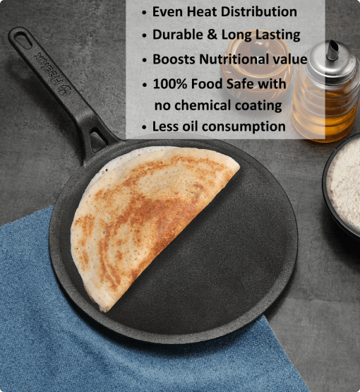 Black cast iron skillet with a quesadilla on a gray surface, surrounded by ingredients.