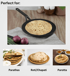 Black frying pan with flatbread on a wooden surface, surrounded by ingredients.