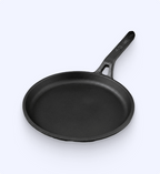 Black cast iron skillet on a white background