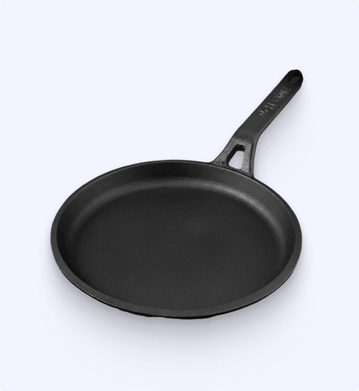 Black cast iron skillet on a white background