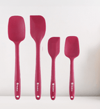 Set of four red silicone spatulas on a white background